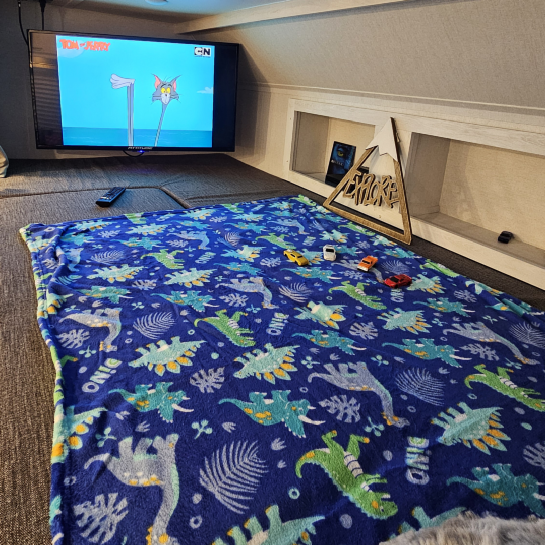 A TV playing Tom and Jerry on a kids bed
