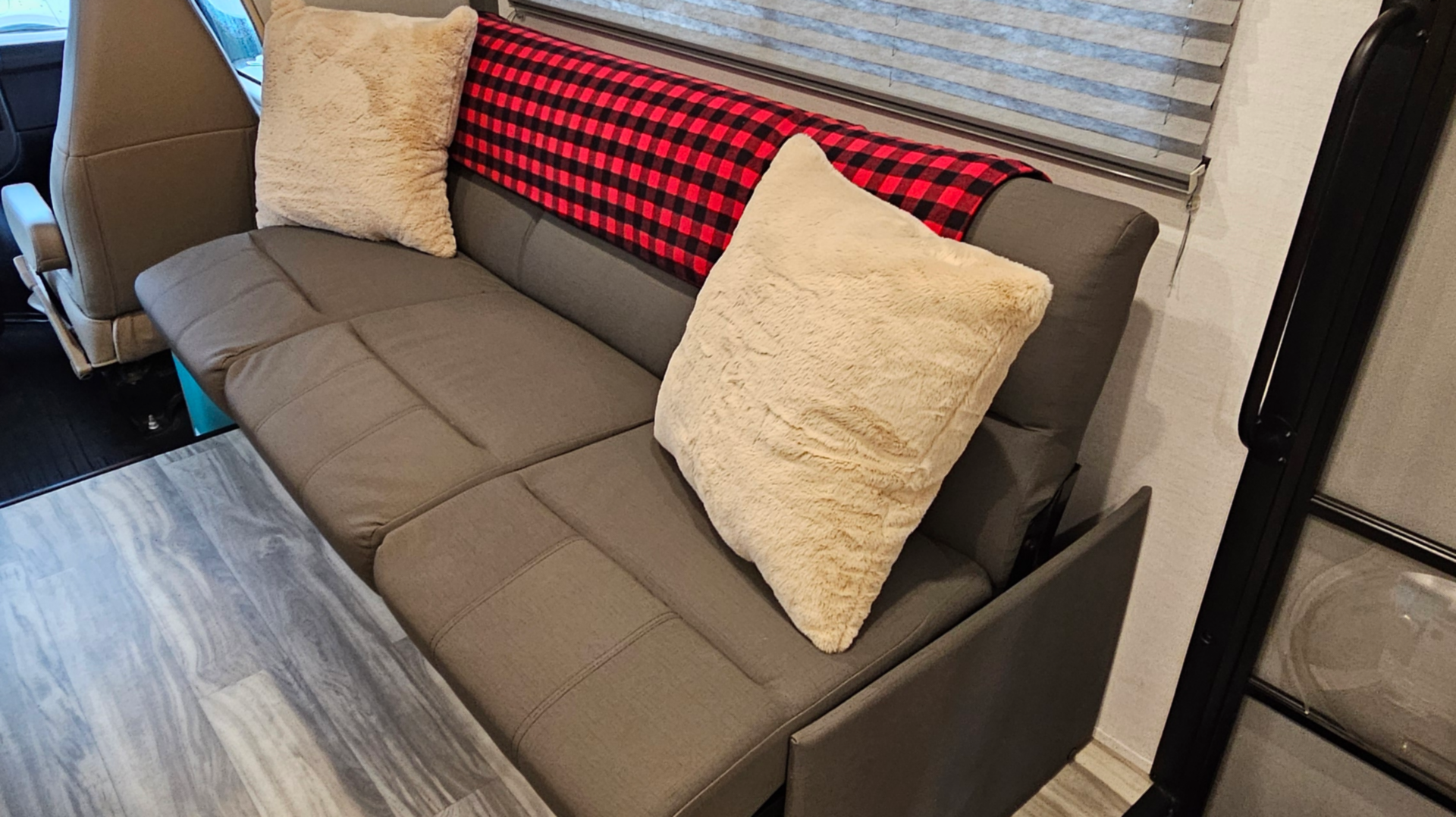 A couch that is turned into a bed in a rv