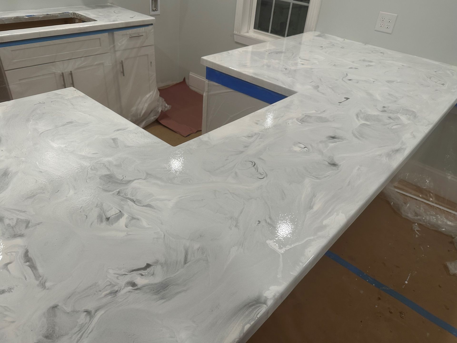 A kitchen with a white counter top and a sink.