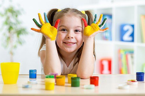 Young girl playing with colours