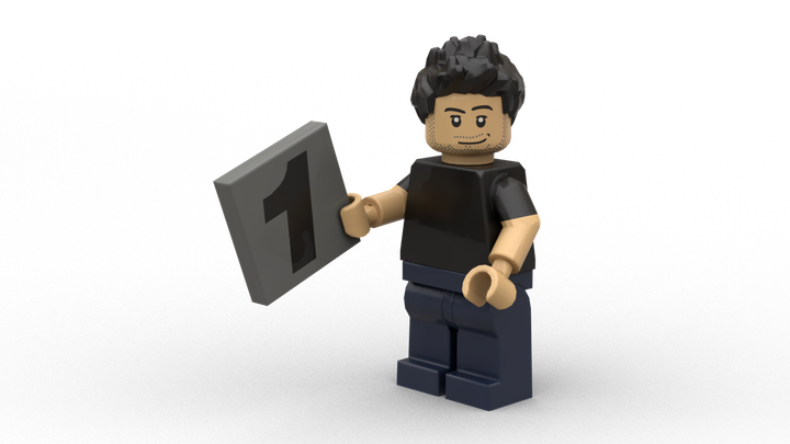 an image of a lego version of Cali, the owner of A Rising Town, holding a brick with the number 1 on it