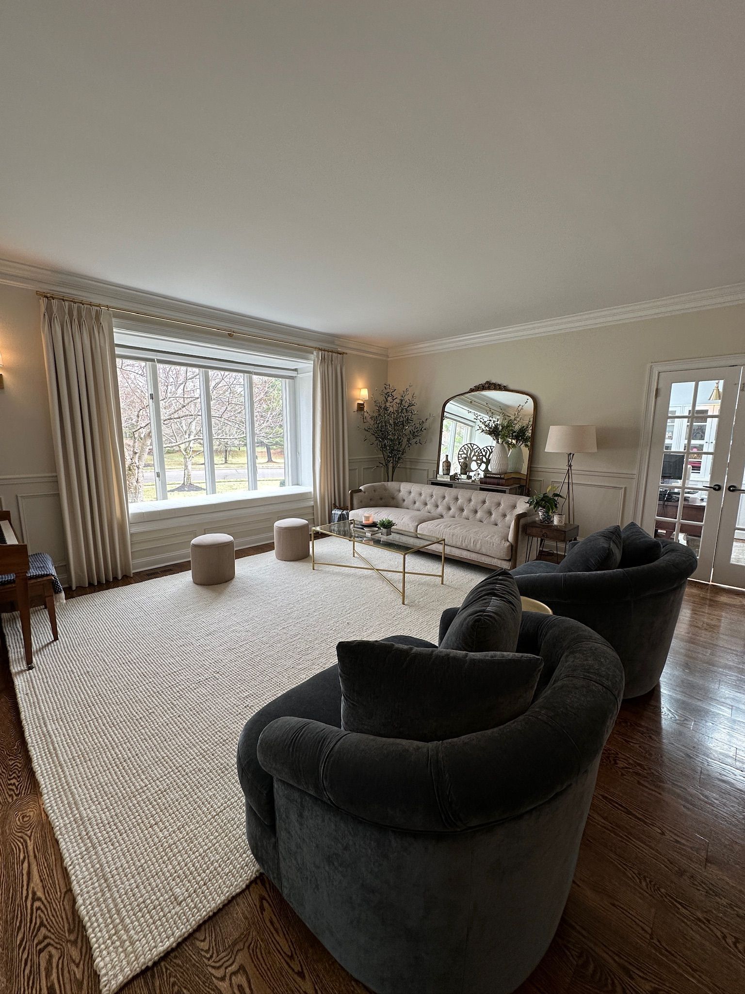 Shelves filled with various wooden chests and furniture in a shop. A lamp sits on a display table.