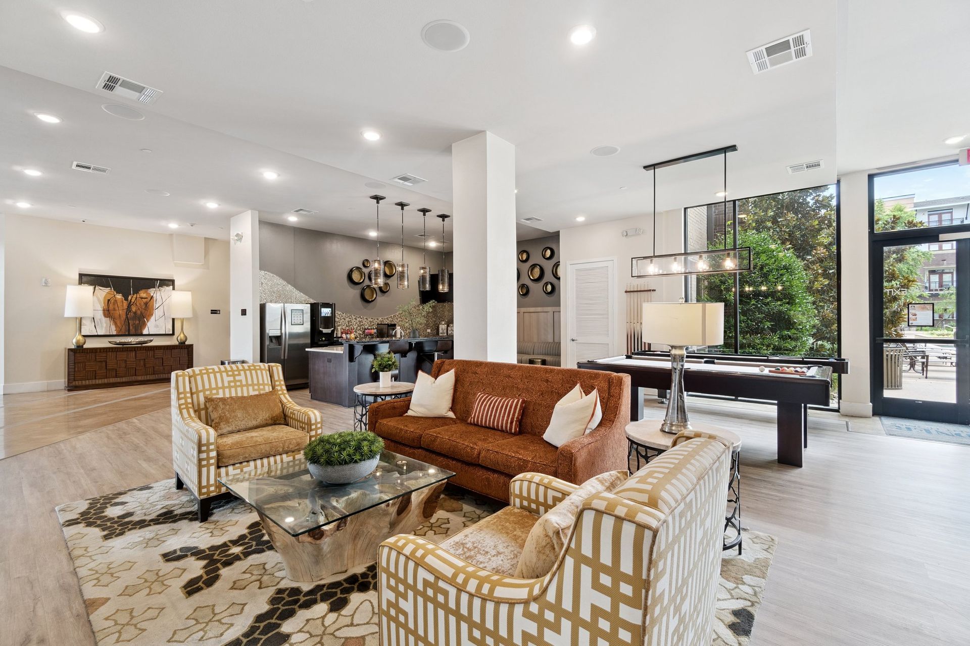 Spacious lobby with seating, pool table, and access to an outdoor area.