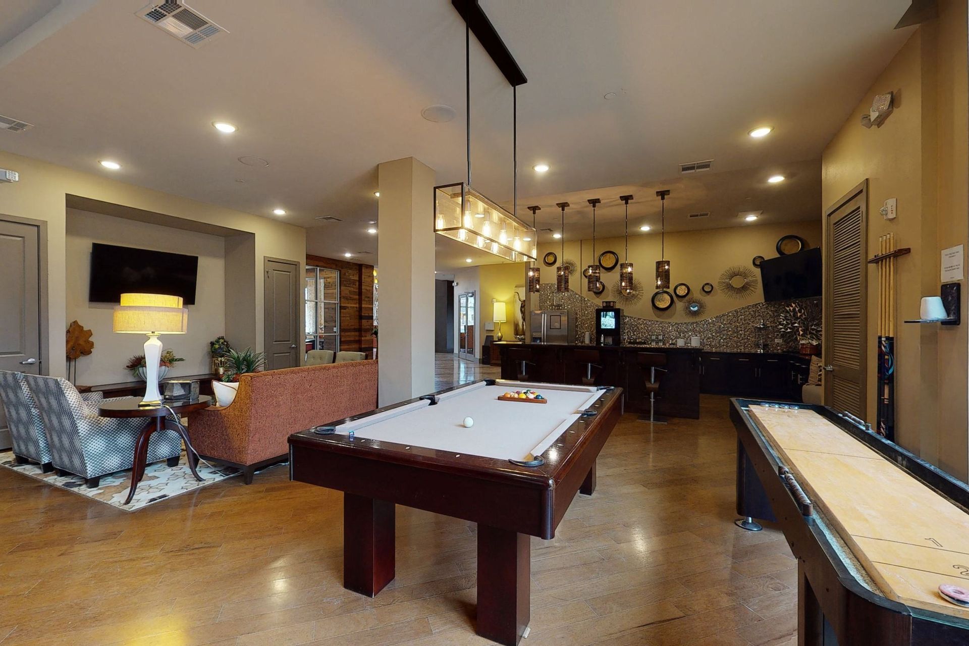 There is a pool table and a shuffleboard in the room.