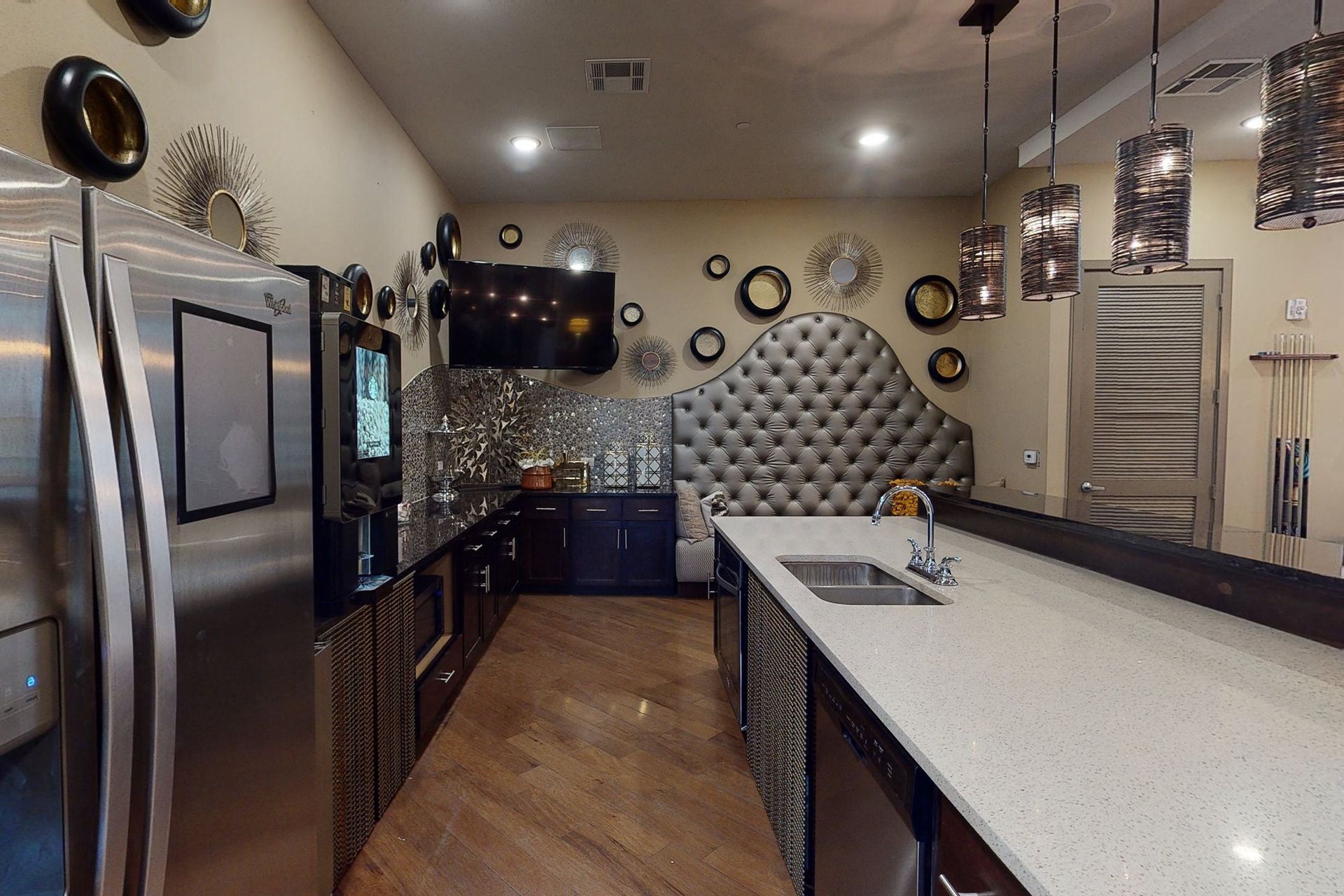 A kitchen with stainless steel appliances and white countertops.