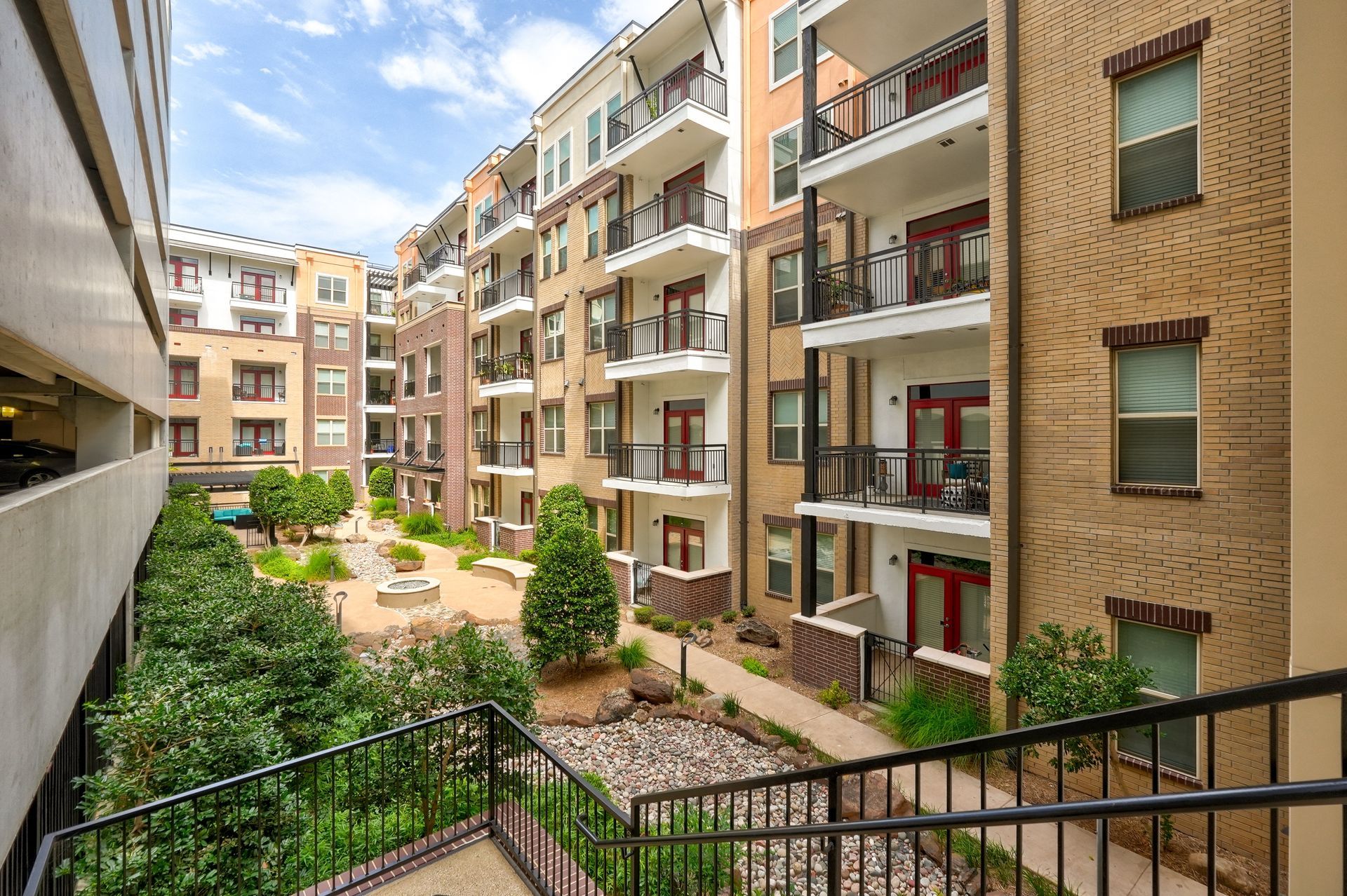 A large apartment building with a lot of balconies and stairs leading to it.