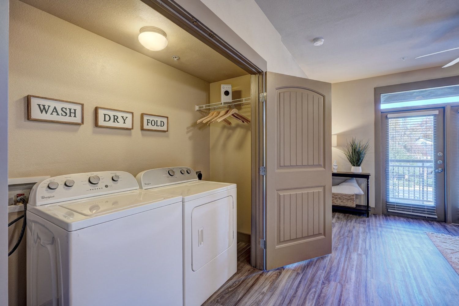 A laundry room with a washer and dryer in an apartment.