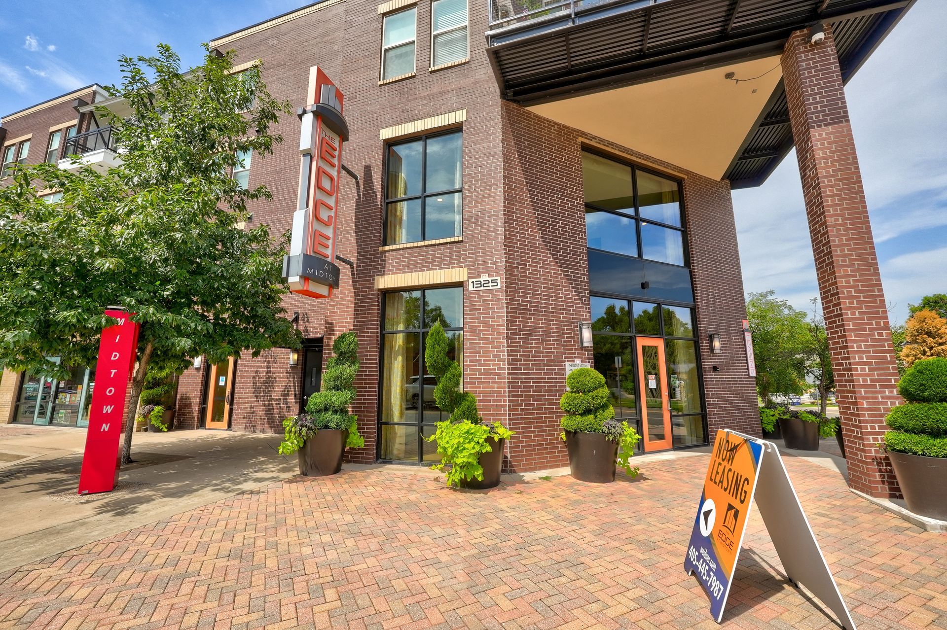 A large brick building with a sign in front of it.