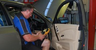 man checking car diagnostics