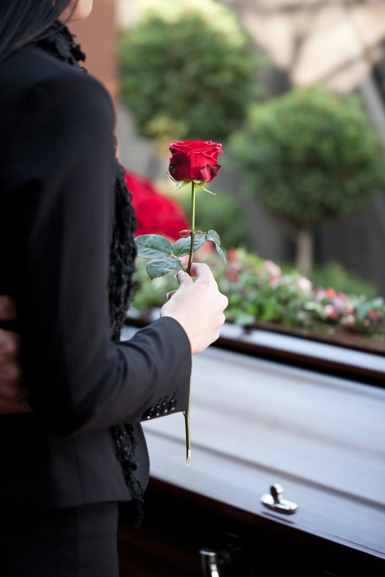 Woman at Funeral with coffin