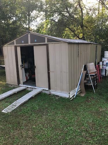 Workers installing post rail and spring assembly for garage doors.