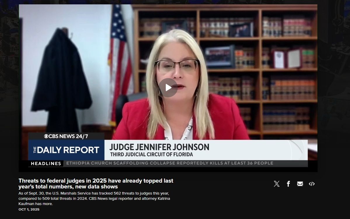 Judge Jennifer Johnson reporting, U.S. flag behind her. News report on threats to federal judges.