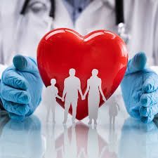 Doctor's hands with blue gloves cradle a red heart with a cutout family inside.