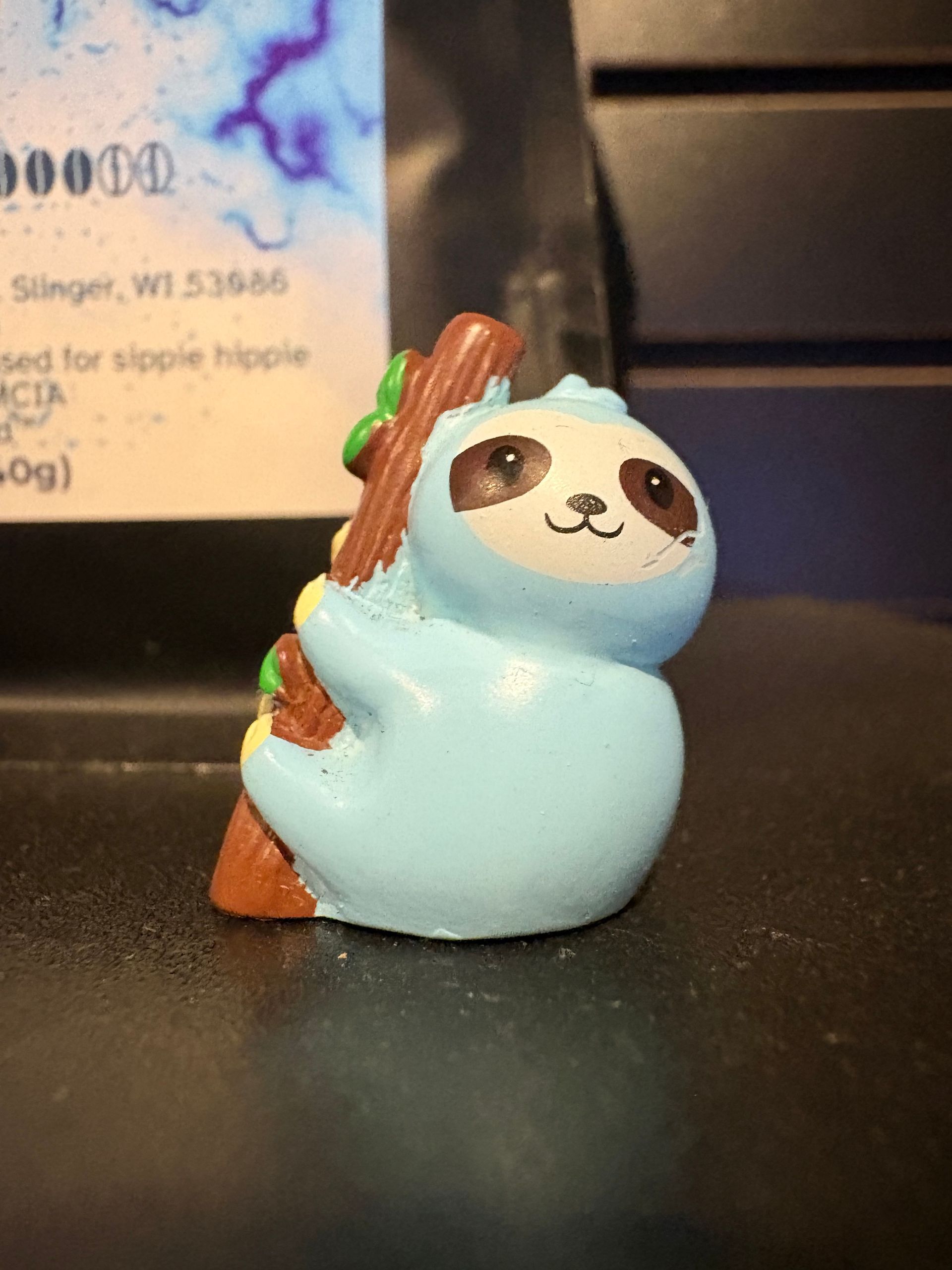 Woman with dark curly hair looking at the camera, sunlight on face, wearing gold earrings, and a yellow top.