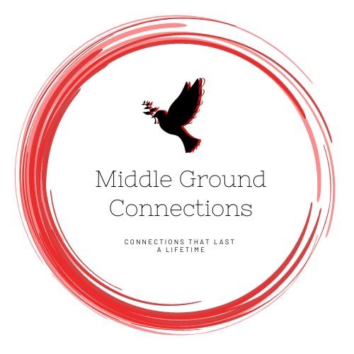 Woman with dark curly hair looking at the camera, sunlight on face, wearing gold earrings, and a yellow top.