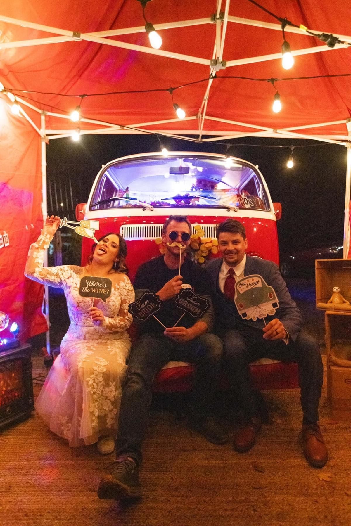 Road at sunset, sun shining through trees, casting golden light on the asphalt.