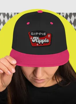 Woman wearing a black and pink cap with