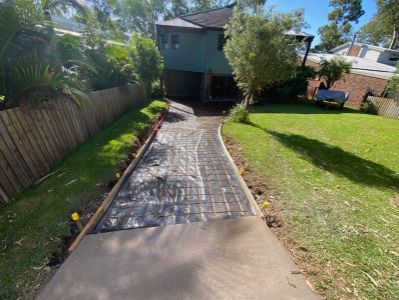 A Concrete Walkway is Being Built in the Backyard — Jaya Rose Earthworks and Landscape Contractors In Gulmarrad, NSW