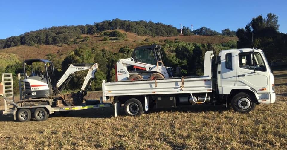 A White Truck With a Trailer — Jaya Rose Earthworks and Landscape Contractors In Gulmarrad, NSW