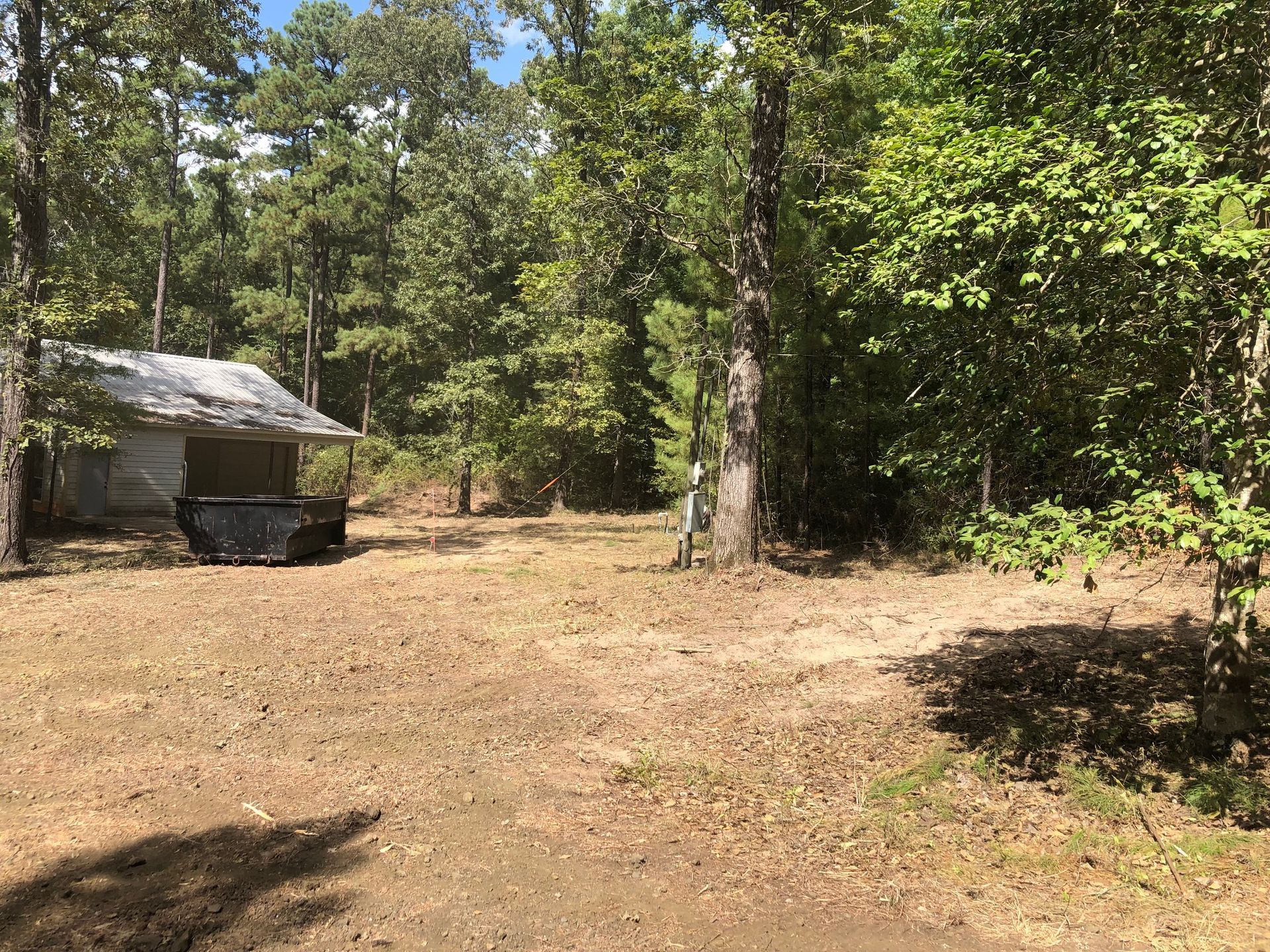 There is a small house in the middle of the woods.