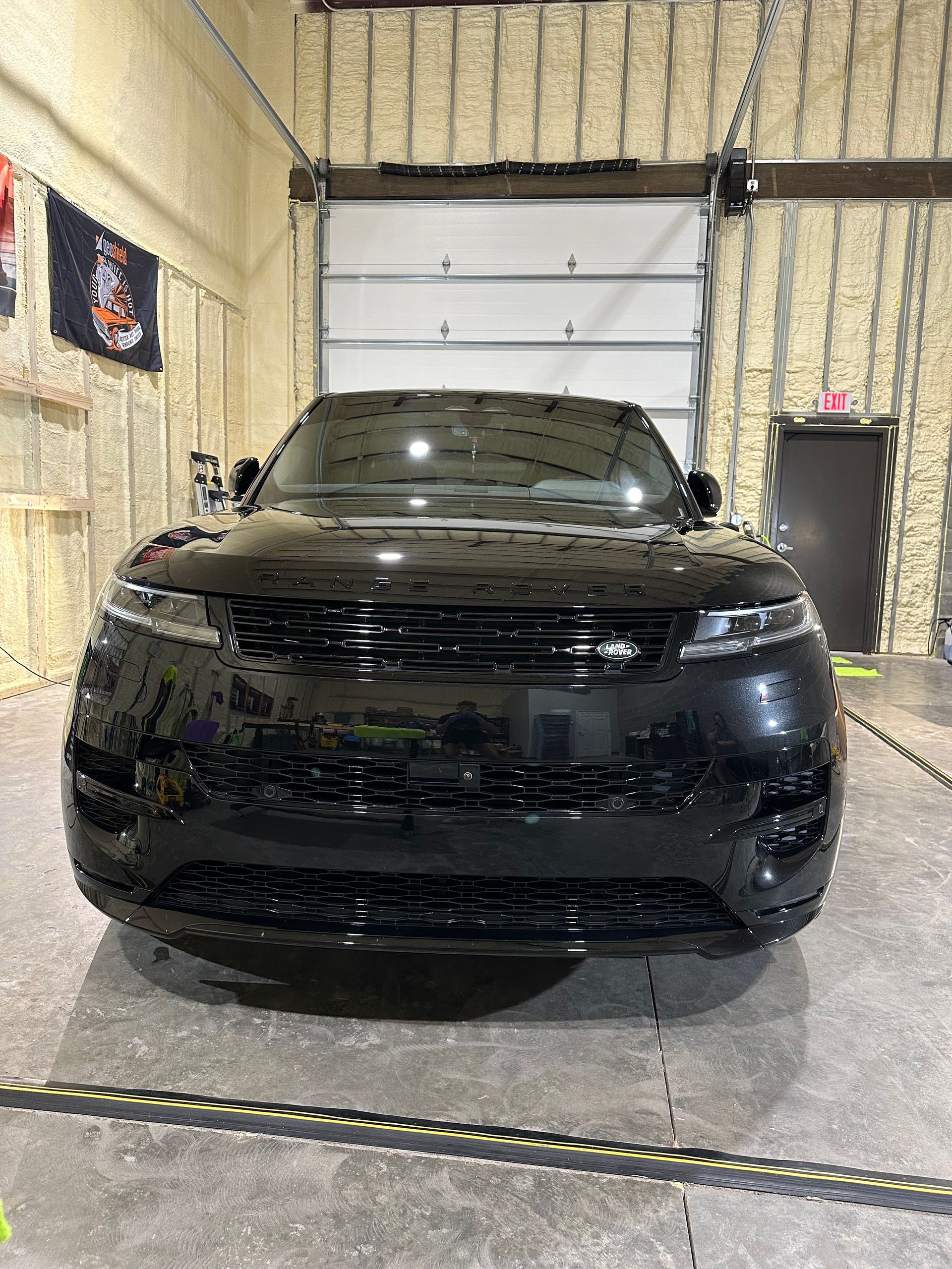 A black range rover velar is parked in a garage.