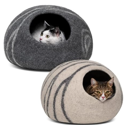 two cats are sitting in rock shaped cat beds