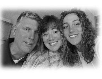 A black and white photo of a family posing for a picture.