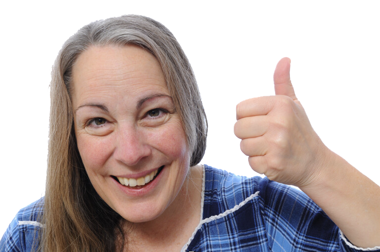 Woman with gray hair smiling, giving thumbs up; wearing blue plaid shirt.
