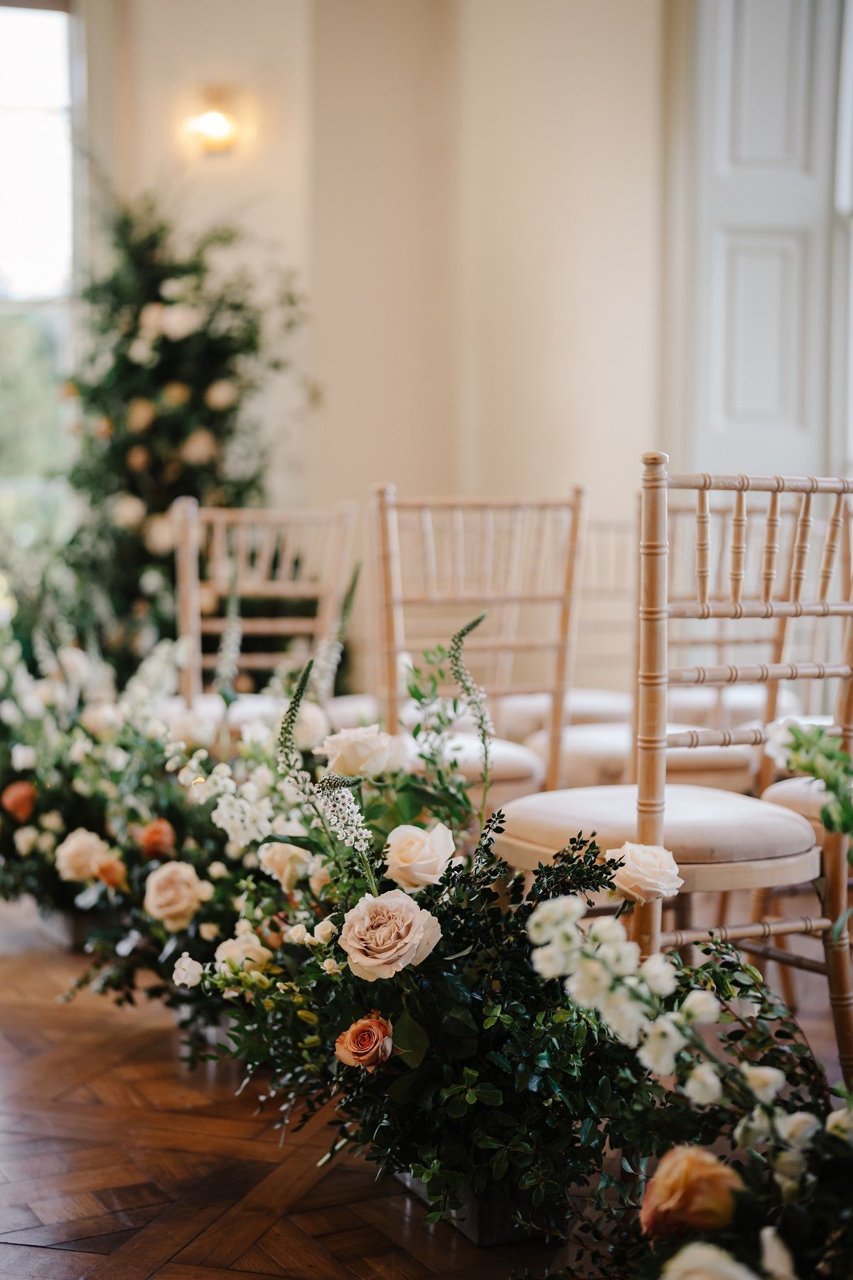 a bride and groom are standing in front of a crowd of people at a wedding ceremony .