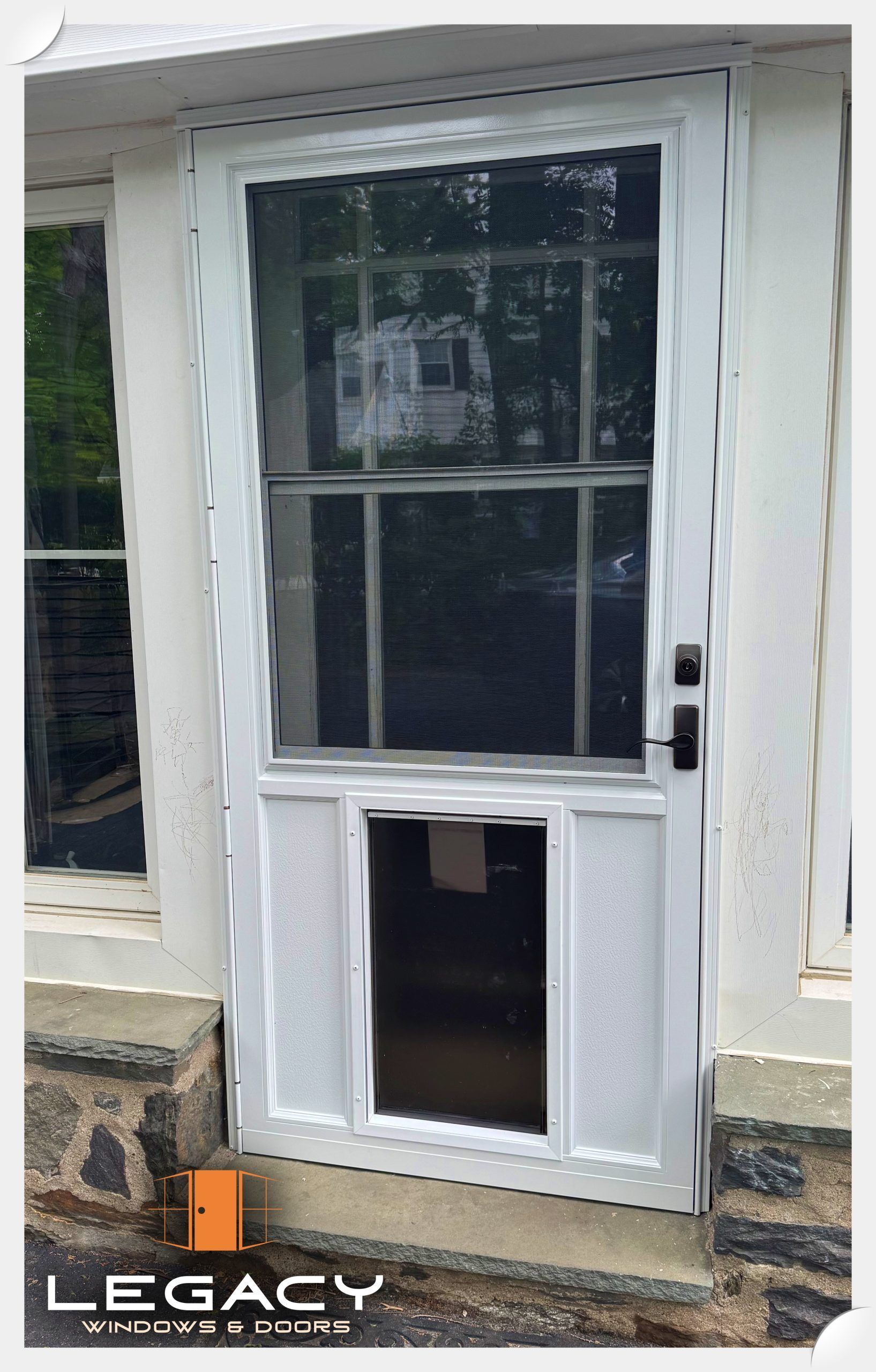 White storm door with glass, screen, and pet door. Houses, outdoors.