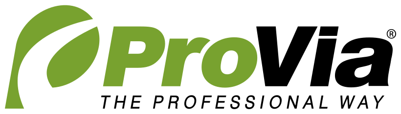 Woman in straw hat smiles, holding wine glass near a lake.