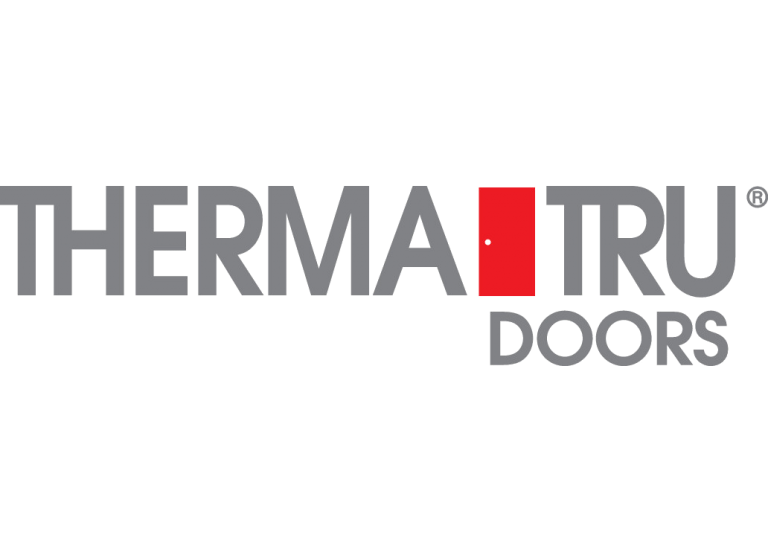 Woman in straw hat smiles, holding wine glass near a lake.