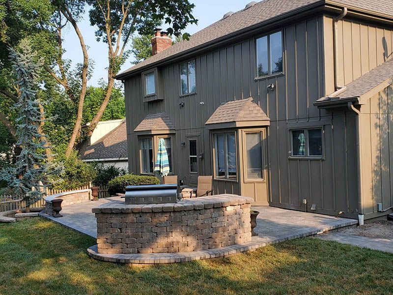 A large house with a patio in front of it.