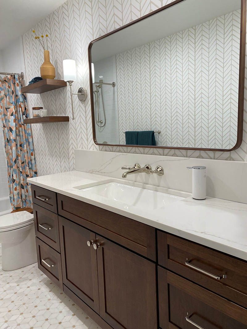 A bathroom with two sinks and a large mirror.