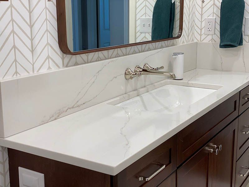 A bathroom with a double sink and a mirror.