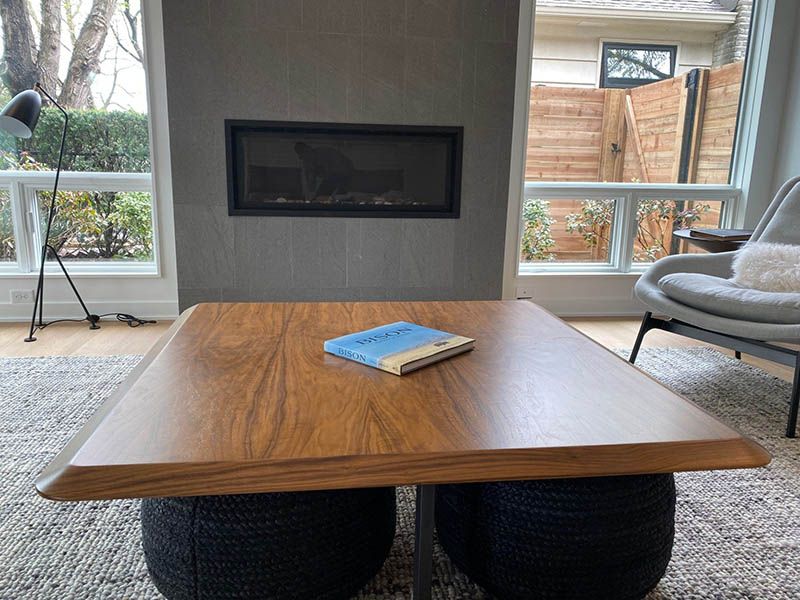 A living room with a wooden coffee table and a fireplace