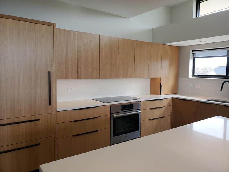 A kitchen with wooden cabinets and stainless steel appliances