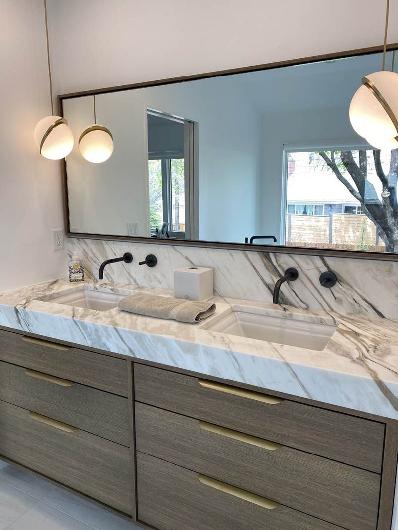 A bathroom with two sinks and a large mirror