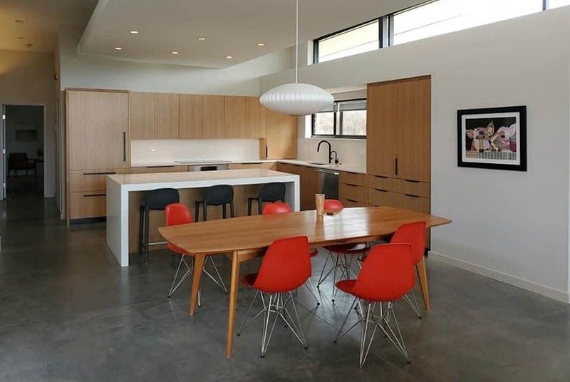 A kitchen with a table and chairs in it