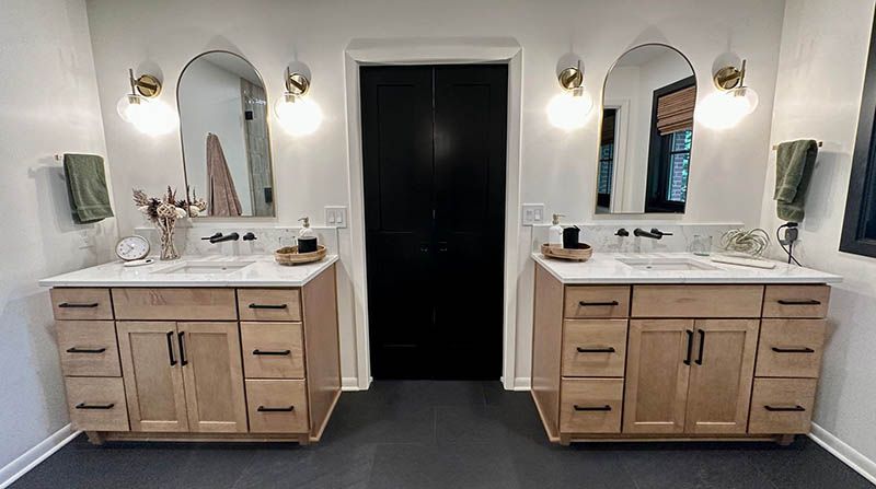 A bathroom with two sinks and two mirrors.