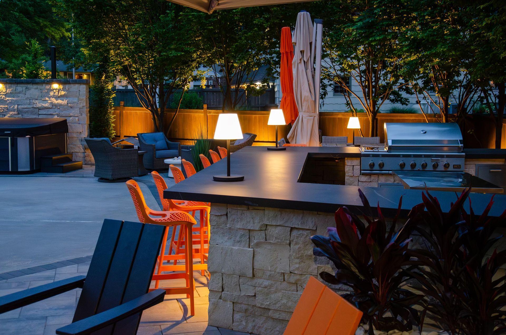 A patio area with chairs and a grill at night