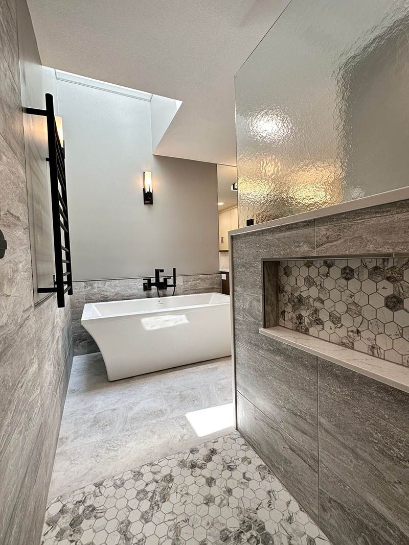 A bathroom with a tub and a shower.