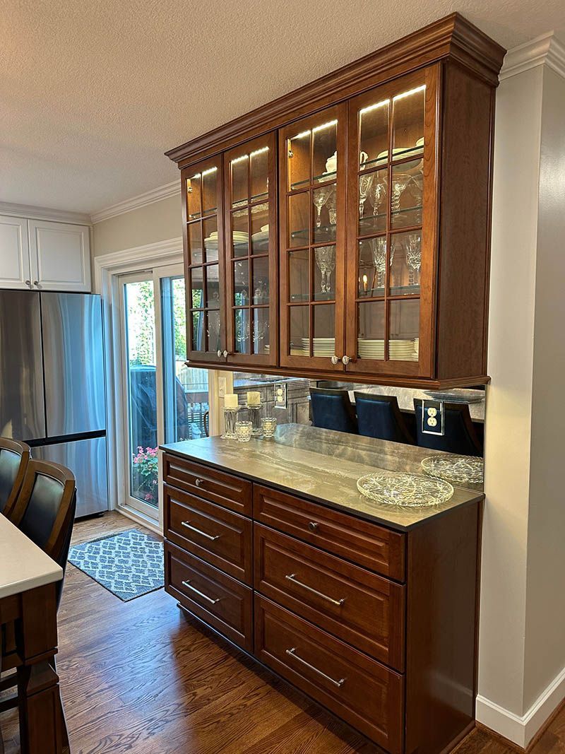 A kitchen with wooden cabinets and a granite counter top.