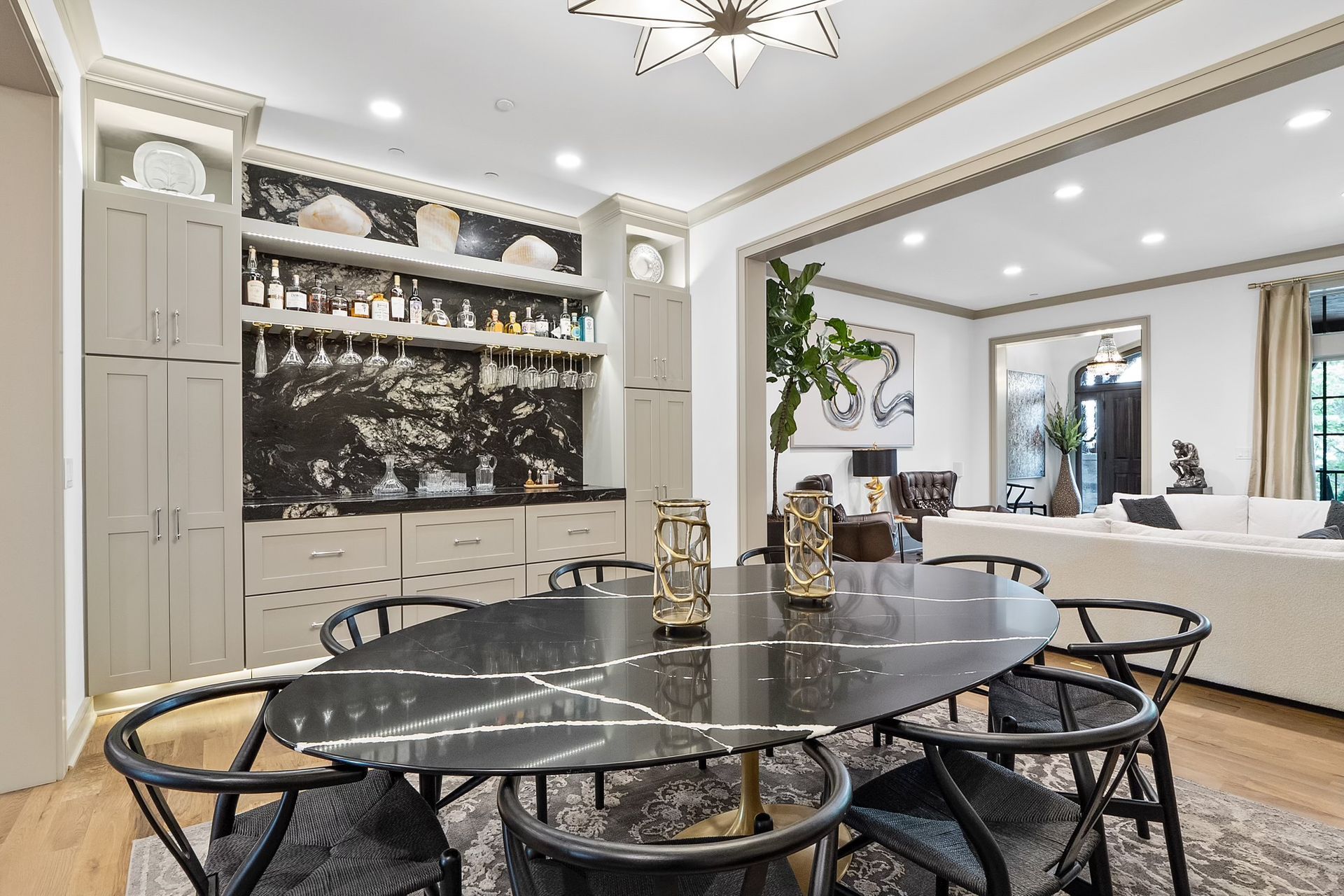 A dining room with a table and chairs and a bar.