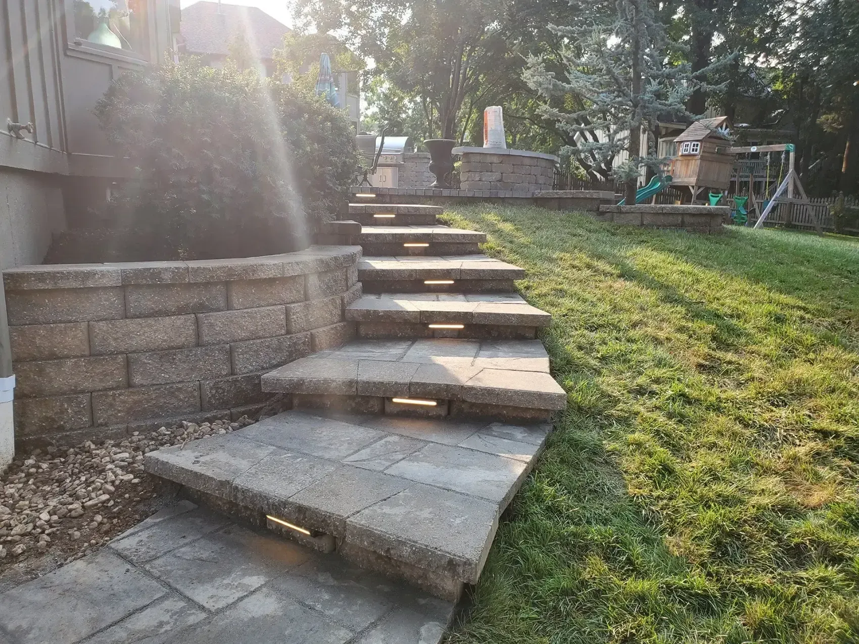 A set of stairs leading up to a house in a backyard.