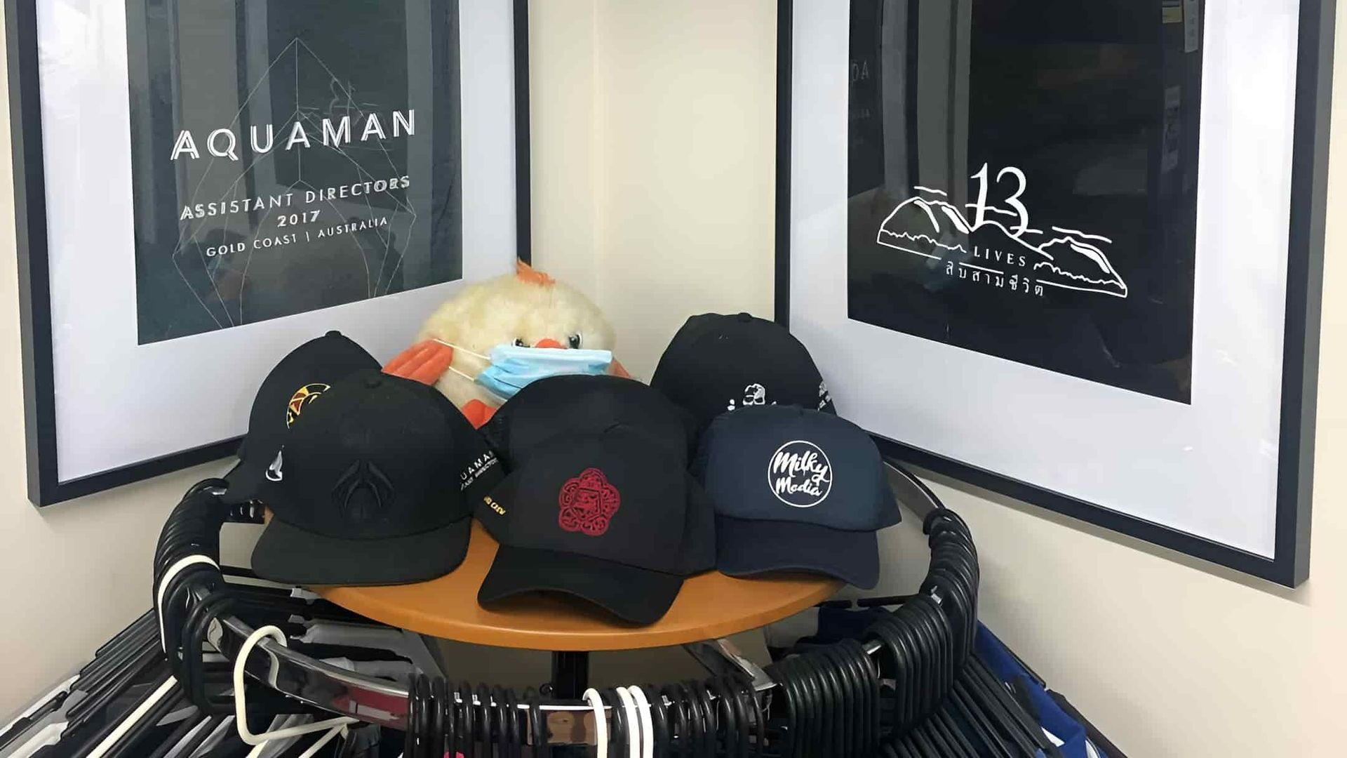 A Bunch Of Hats Are Sitting On Top Of A Wooden Table — Carnival Clothing In Miami, QLD