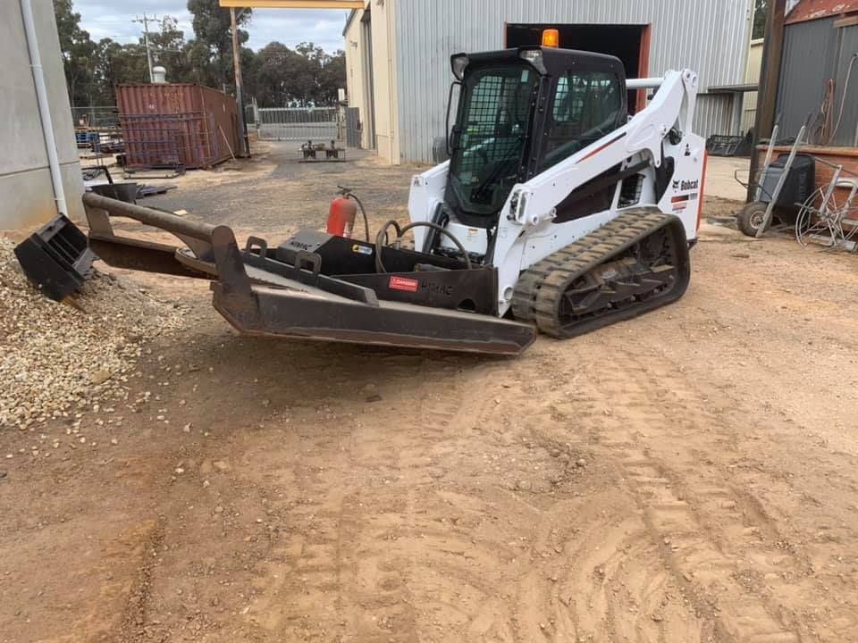 A Bulldozer Is Parked In A Dirt Lot In Front Of A Building — Dicko's Bobcat & Tipper in East Bendigo, VIC