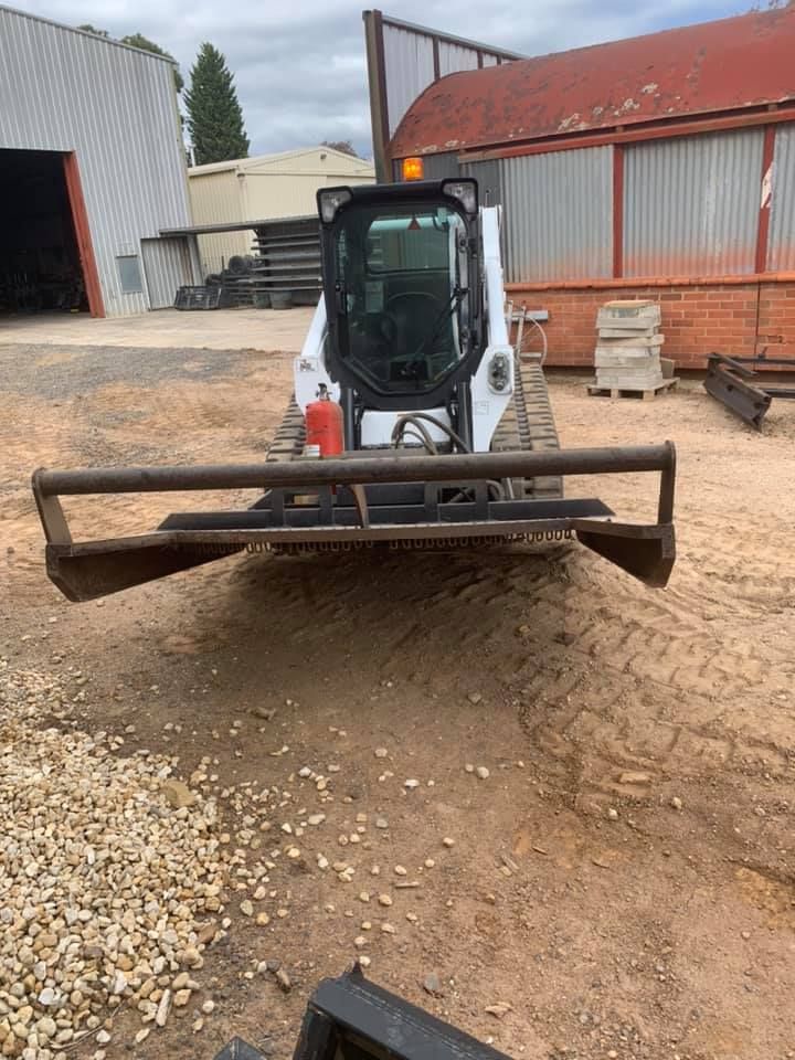 A Bulldozer Is Parked In A Dirt Lot In Front Of A Building — Dicko's Bobcat & Tipper in East Bendigo, VIC