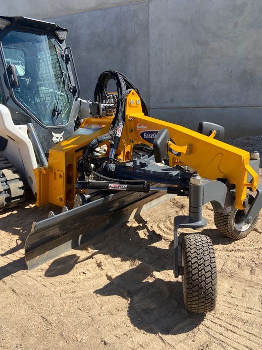 A Bulldozer With A Ruler Attached To It Is Parked In The Dirt — Dicko's Bobcat & Tipper in East Bendigo, VIC