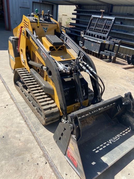 A Small Bulldozer Is Parked On The Side Of The Road — Dicko's Bobcat & Tipper in East Bendigo, VIC